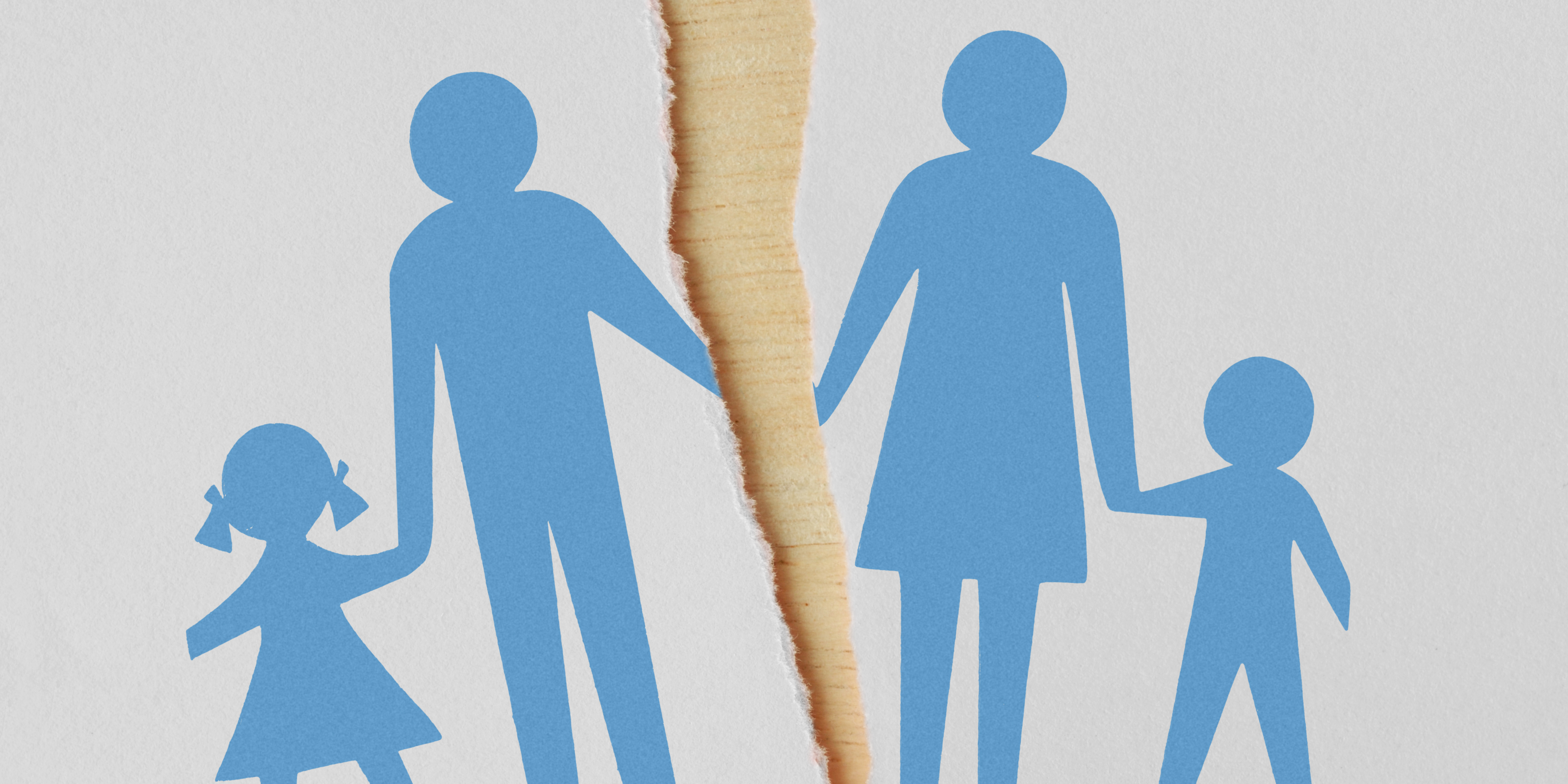 A torn paper dividing a blue silhouette of a family—two parents holding hands with a young girl and boy—symbolizing separation or divorce.