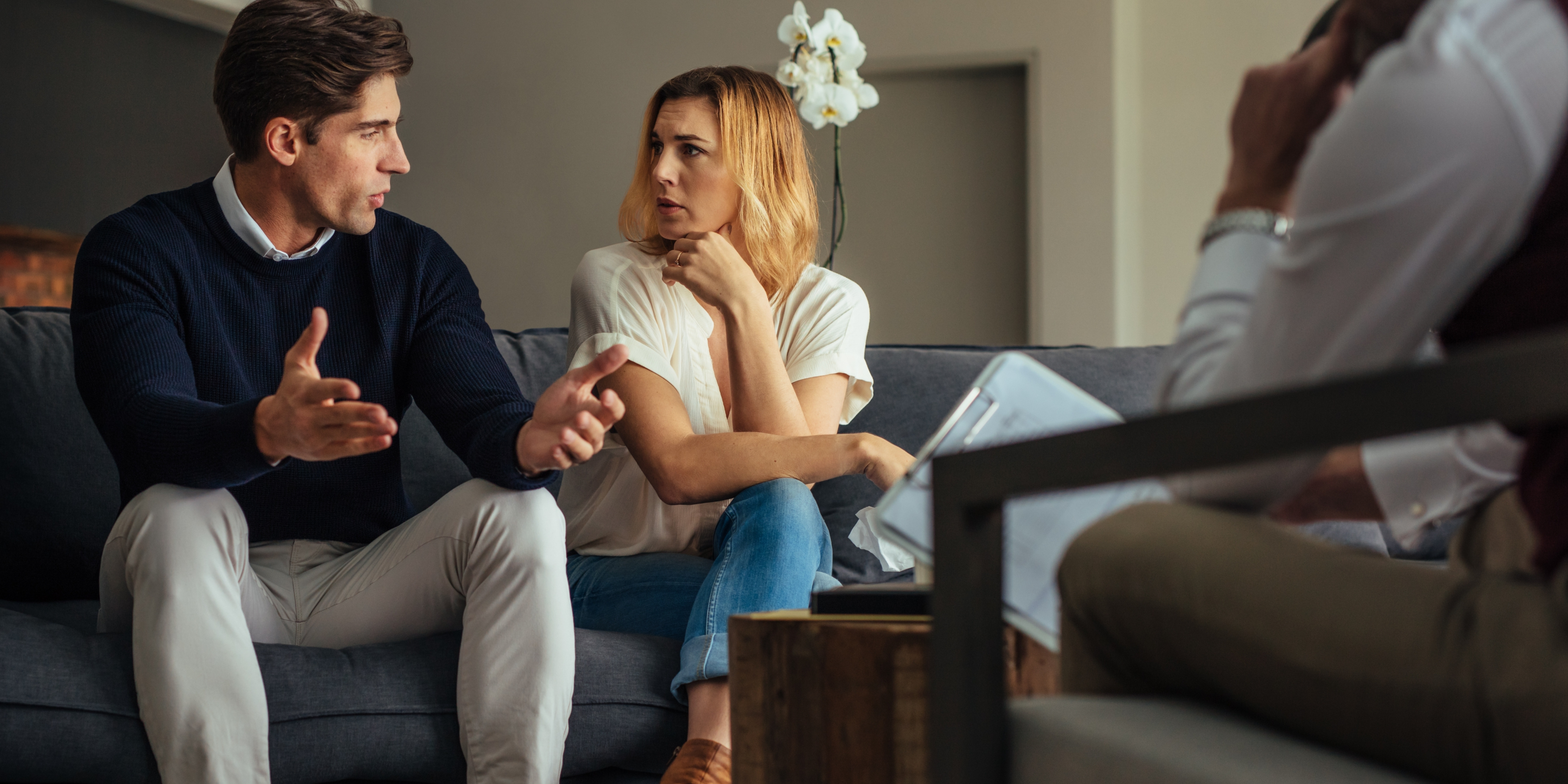 Couple in discussion during a counseling or legal consultation, representing divorce decisions and the complexities of bifurcating marital status from other issues.