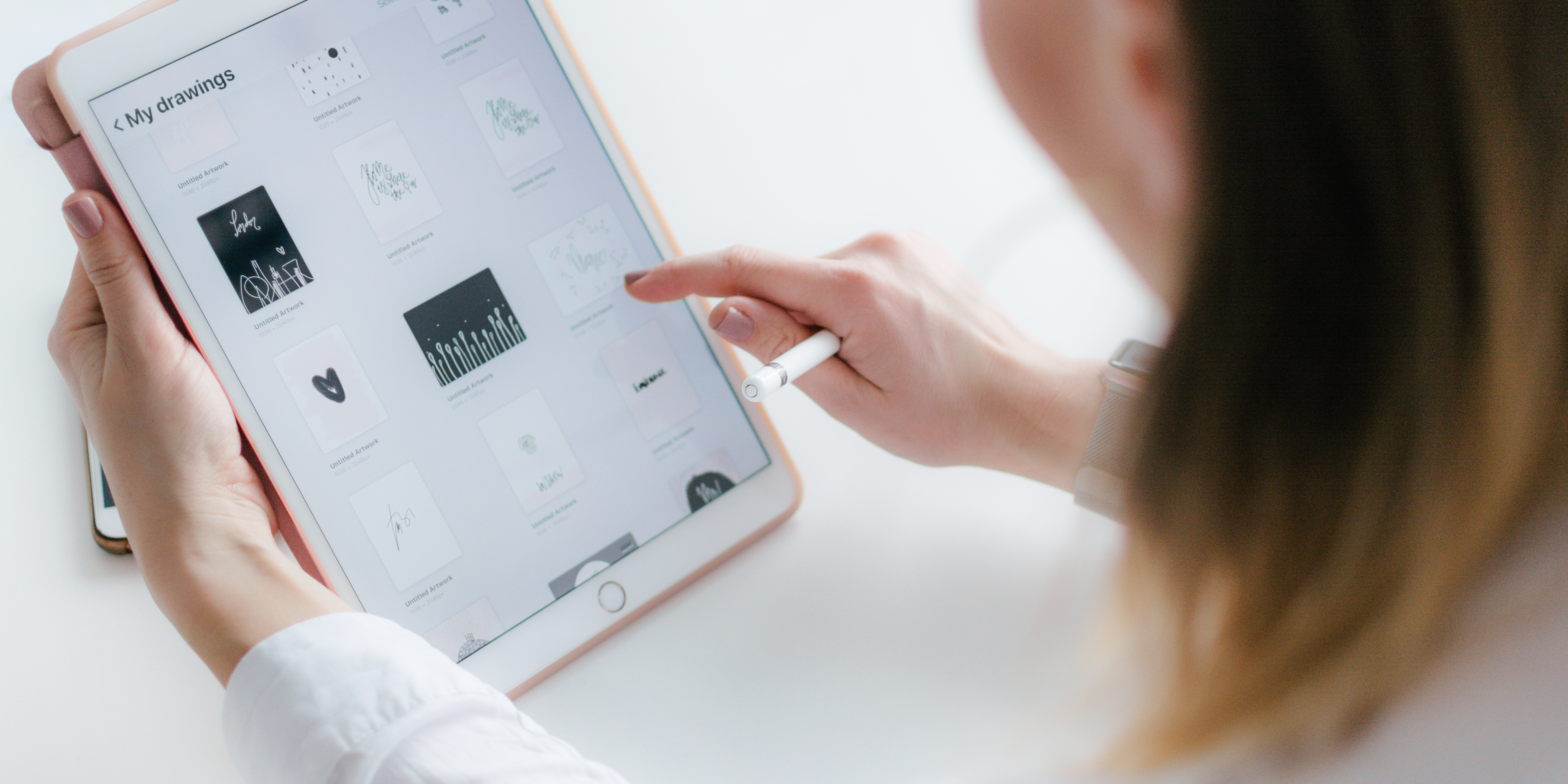 Woman using a digital tablet and stylus to manage files, symbolizing online privacy, digital estate planning, and protecting digital assets during and after divorce.