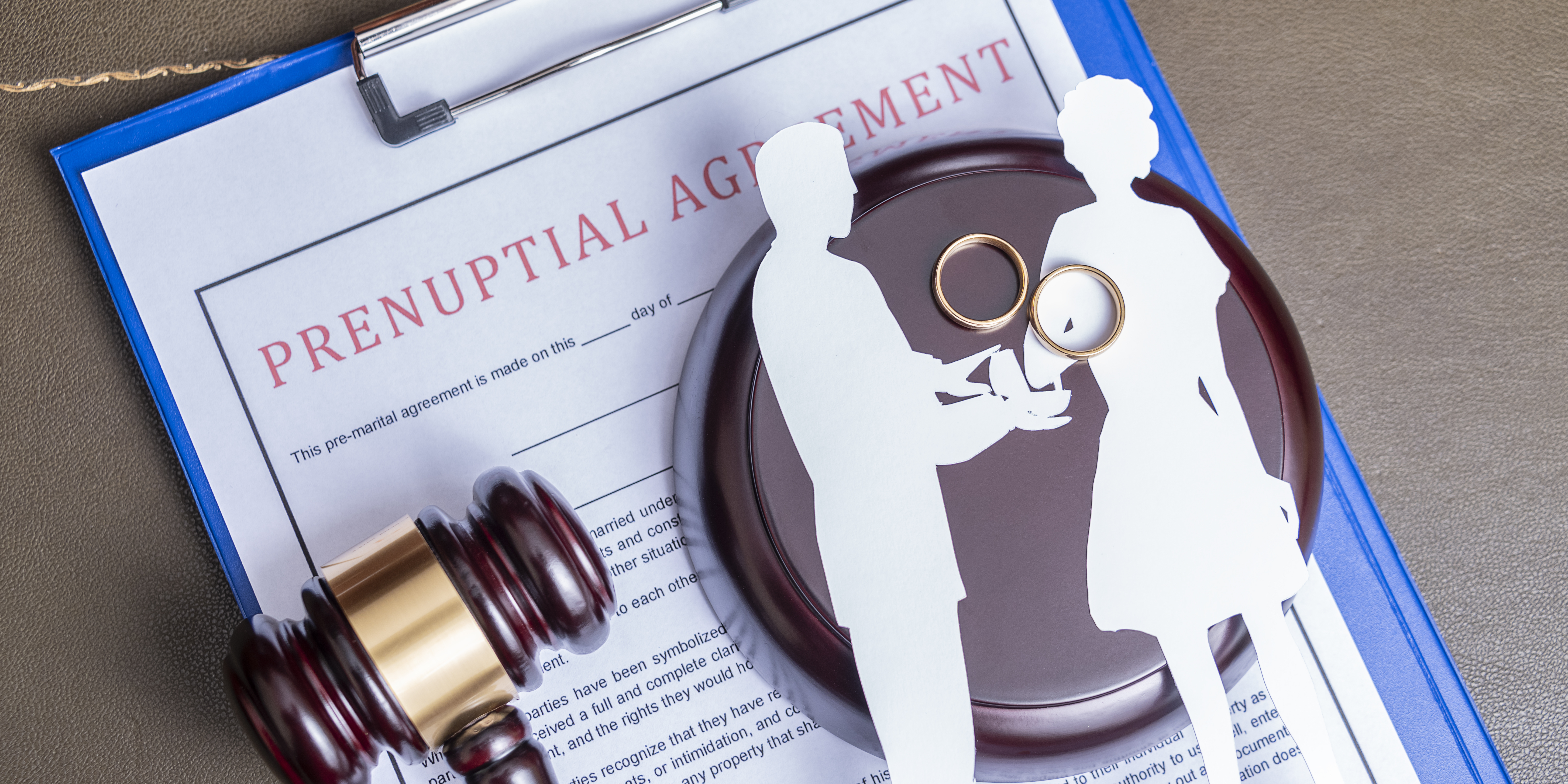 Prenuptial agreement document with wedding rings and a gavel, symbolizing legal planning before marriage