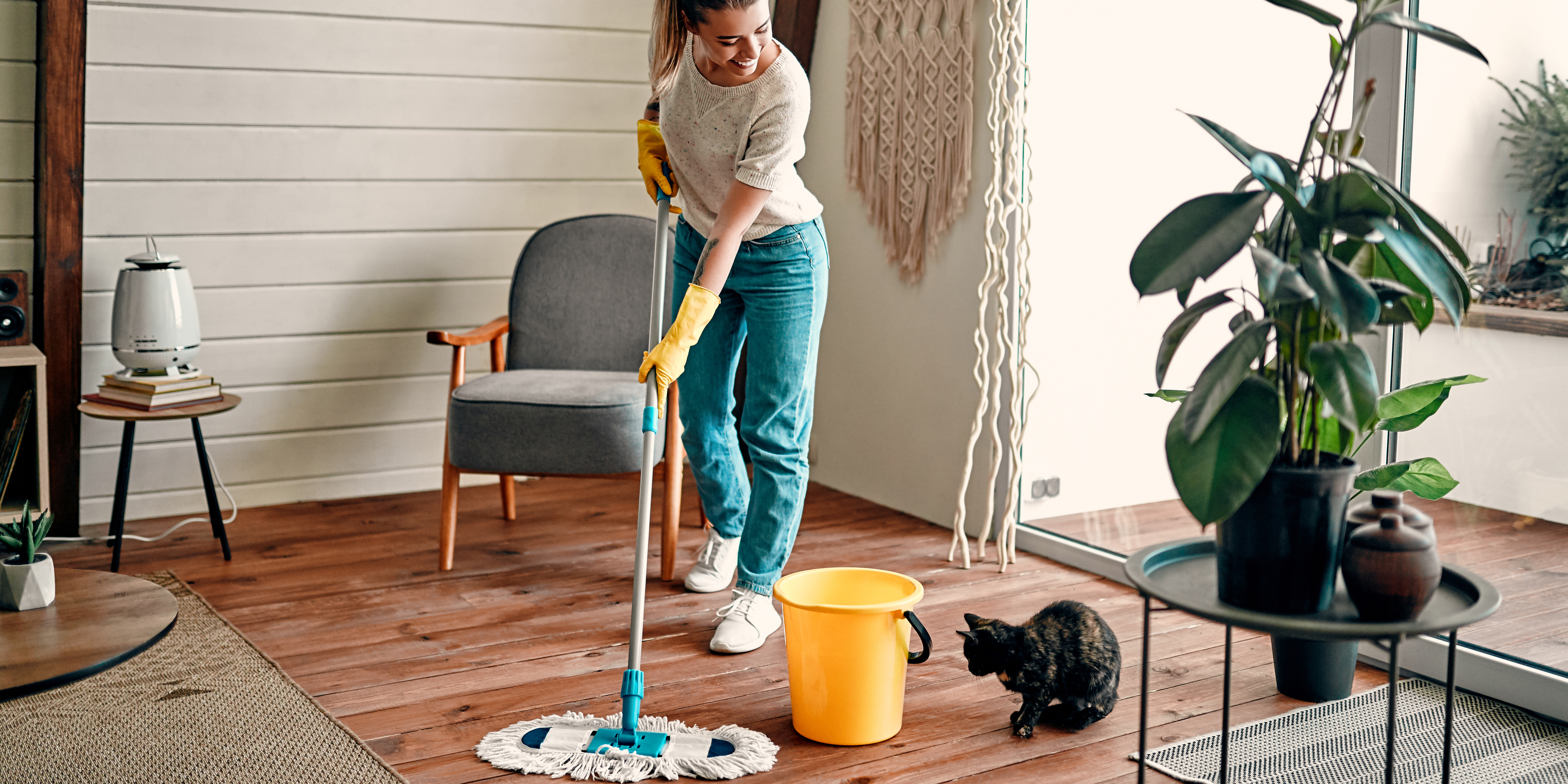 Person spring cleaning a living room, symbolizing letting go of unhealthy relationships and starting fresh emotionally